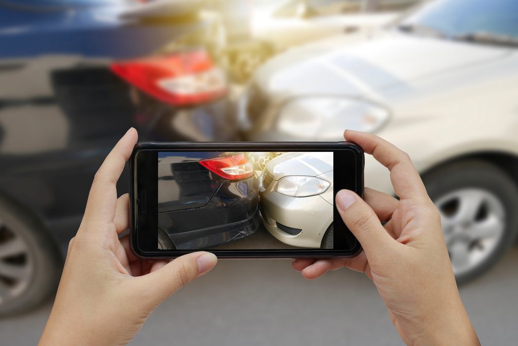 Close up hand holding smartphone and take photo at The scene of