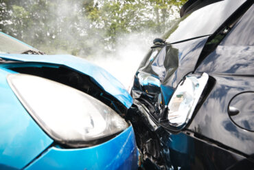 A close-up of two vehicles following a rear-end collision