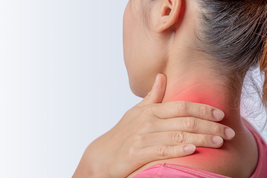 delayed-injury-car-accident A woman holds her neck, illustrated with a red glow to indicate pain