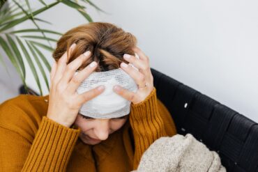A stressed woman with a bandaged head following a personal injury incident